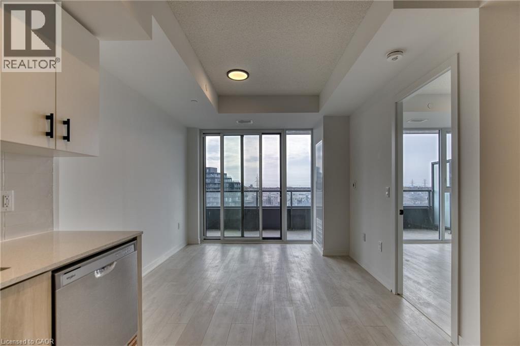 A realtor logo is on the wall in a spacious apartment.