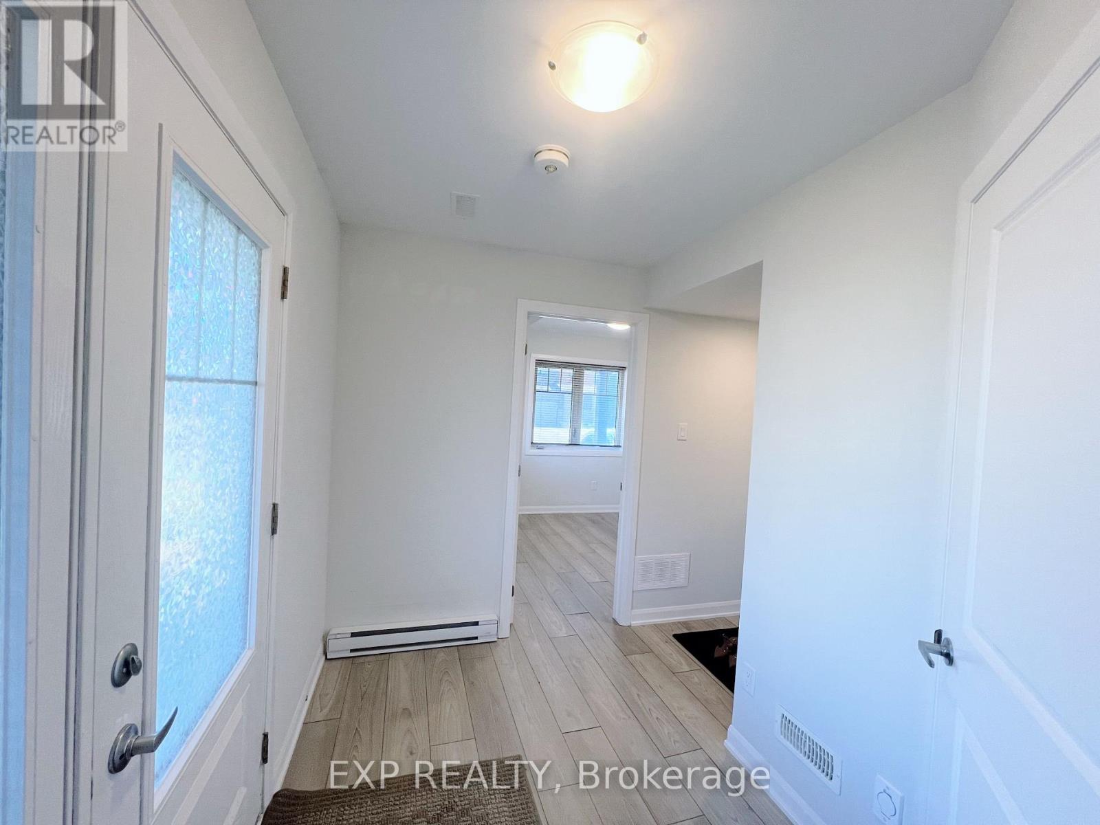 A white room with a door and a window.