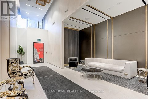 A modern living room with a white sofa and a black and gold chair.