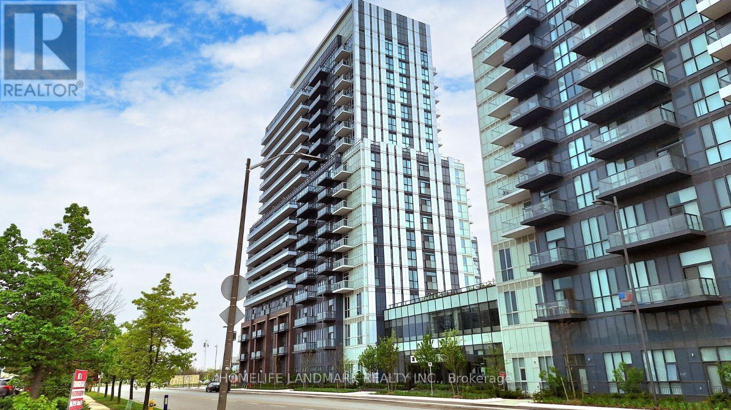 A modern apartment building with a glass facade stands tall in the foreground.