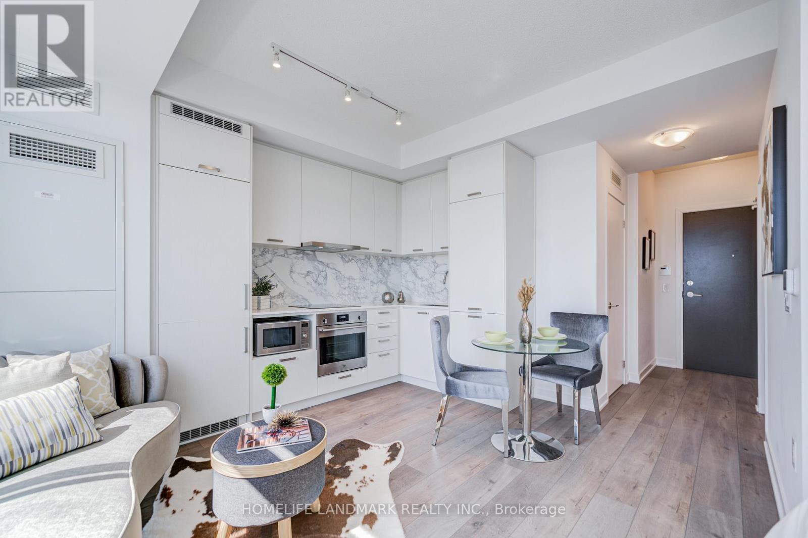 A modern kitchen with a dining table and chairs.
