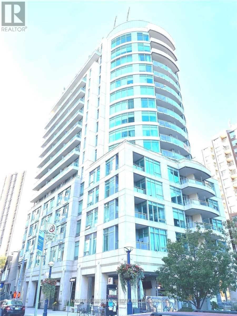 A tall building with many windows and balconies is shown.