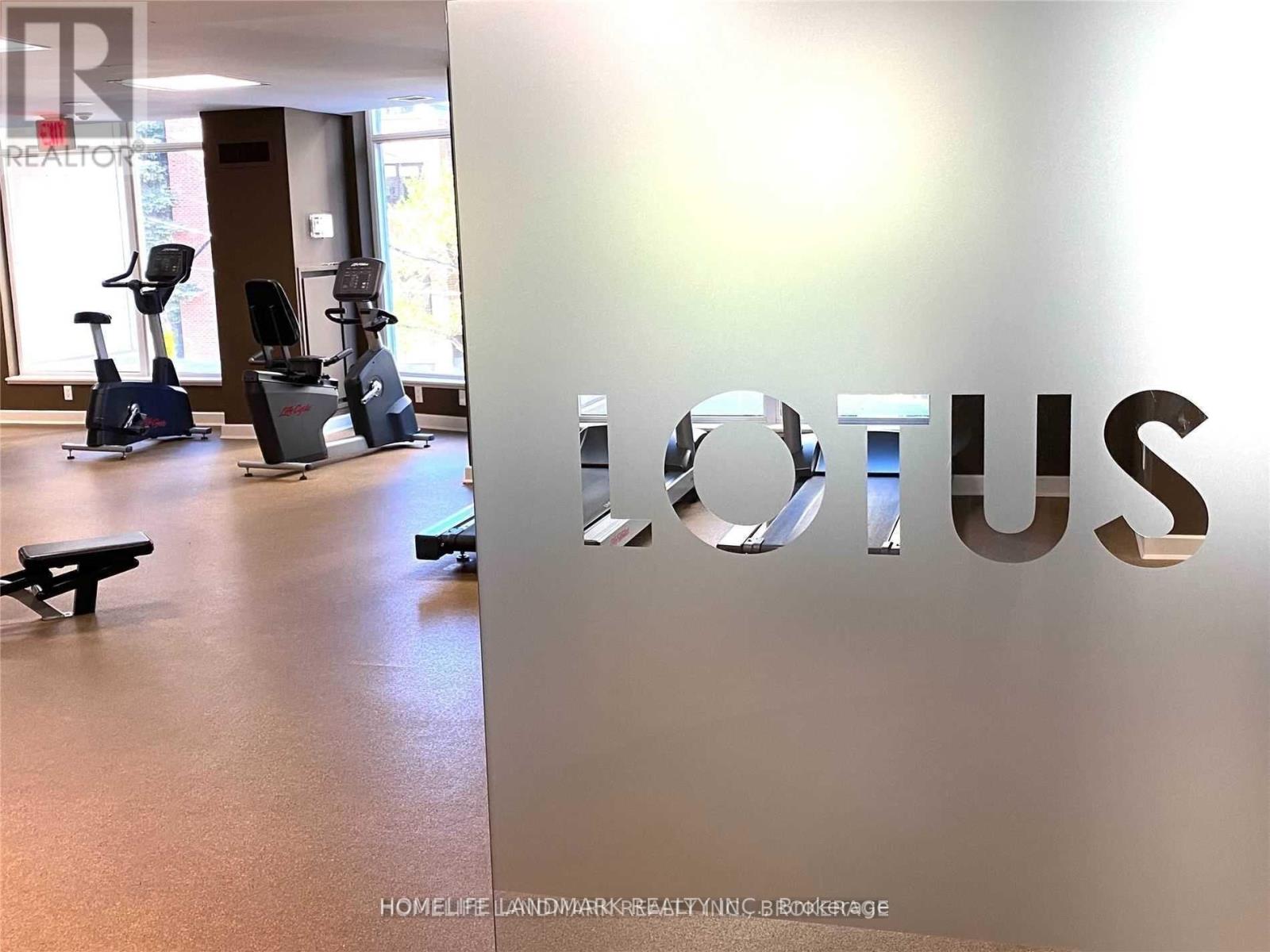 A gym with a row of exercise bikes and a sign that says Lotus.