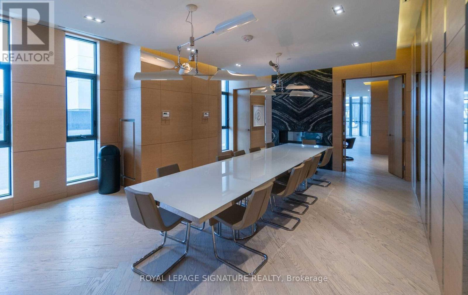 A conference room with a long table and chairs.