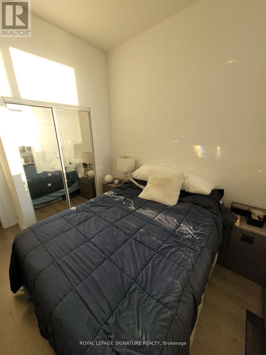 A bedroom with a large bed and a window.