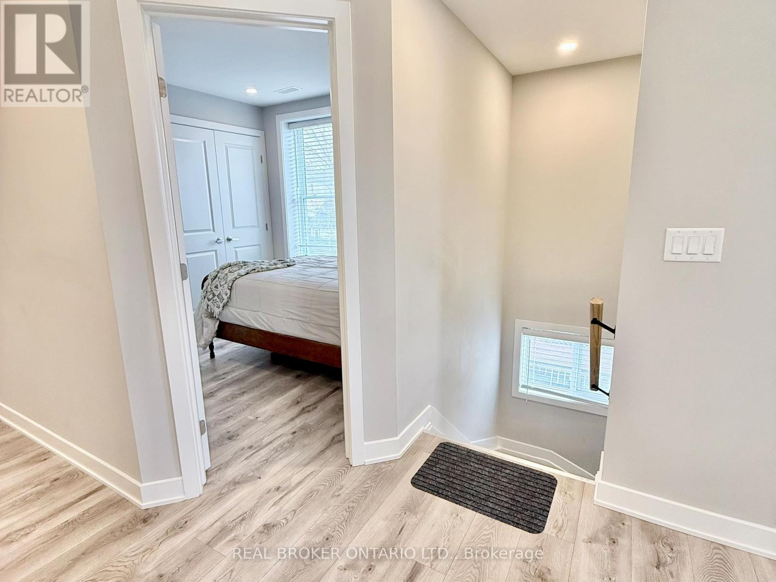 A bedroom with a bed and a window.
