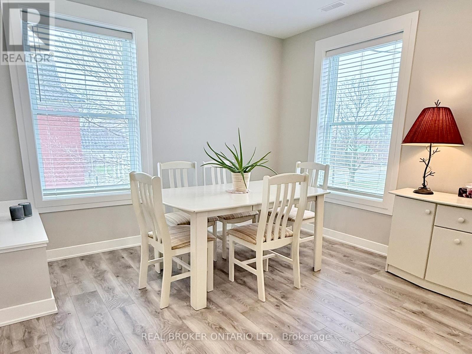 A dining room with a white table and chairs.
