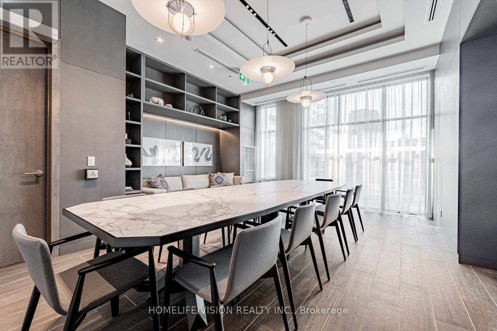 A modern dining room with a large table and chairs.