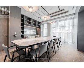 A modern dining room with a large table and chairs.
