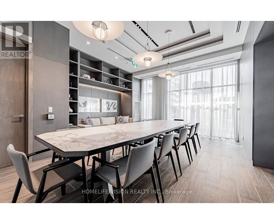 A modern dining room with a large table and chairs.