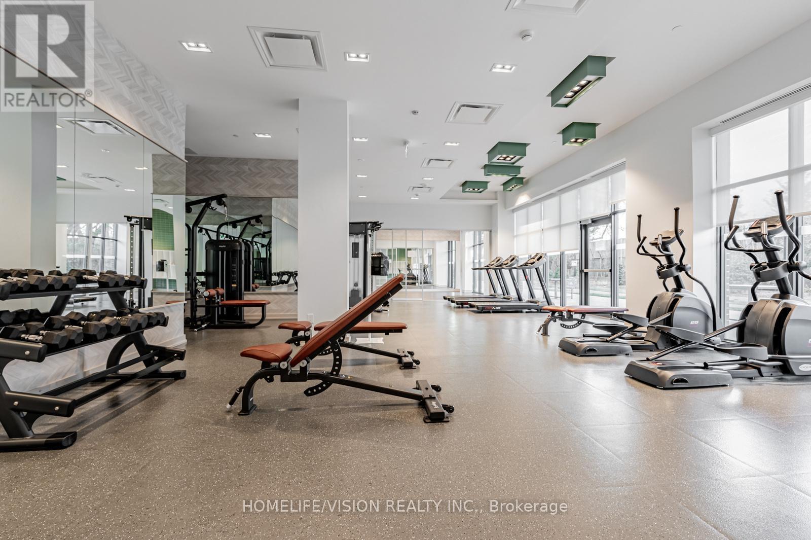 A gym with a variety of equipment including treadmills, weights, and exercise machines.