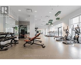 A gym with a variety of equipment including treadmills, weights, and exercise machines.