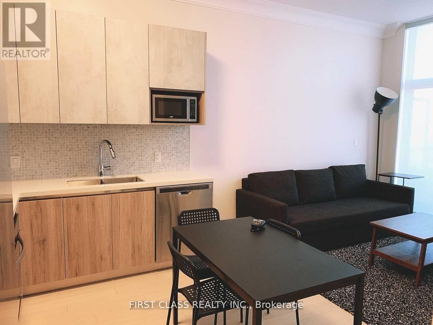 A kitchen with a table and chairs in the middle of the room.