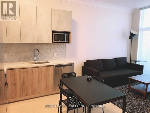 A kitchen with a table and chairs in the middle of the room.