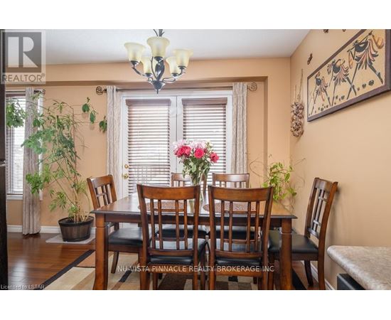 A dining room with a wooden table and chairs.