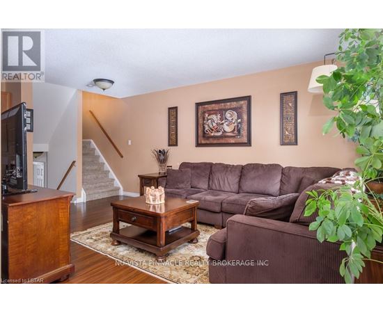 A living room with a brown couch and a wooden coffee table.