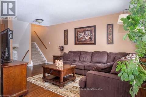 A living room with a brown couch and a wooden coffee table.