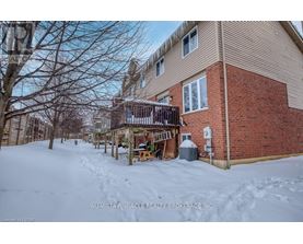 A snow-covered ground with a building in the background.