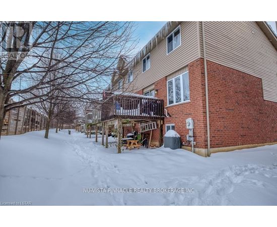 A snow-covered ground with a building in the background.