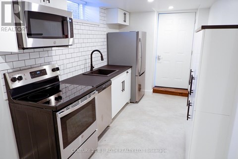 A kitchen with a stove top oven, microwave, and refrigerator.