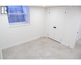 A white door is in a room with a window.