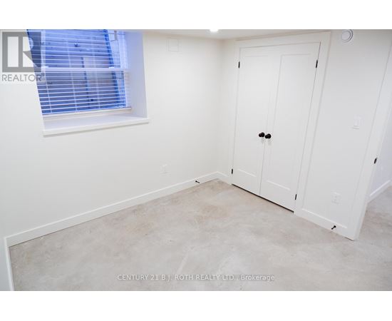 A white door is in a room with a window.