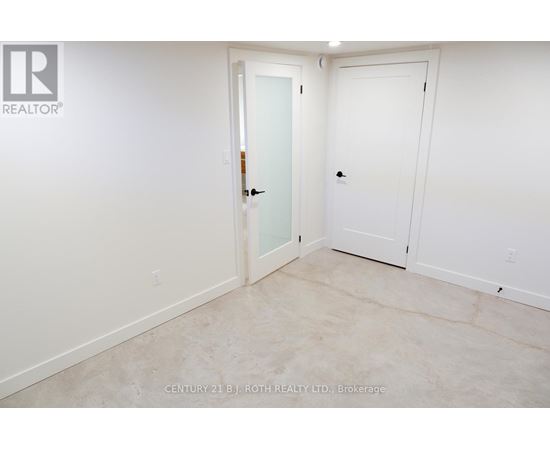 A white door is in a room with a white wall.
