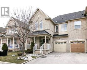 A two-story house with a garage is for sale.