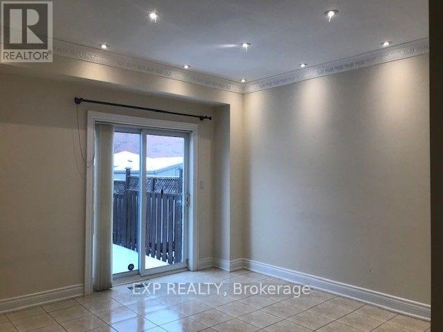 A room with a sliding glass door leading to a backyard.