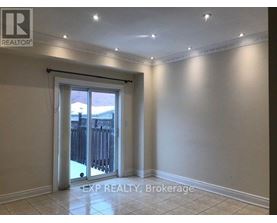 A room with a sliding glass door leading to a backyard.
