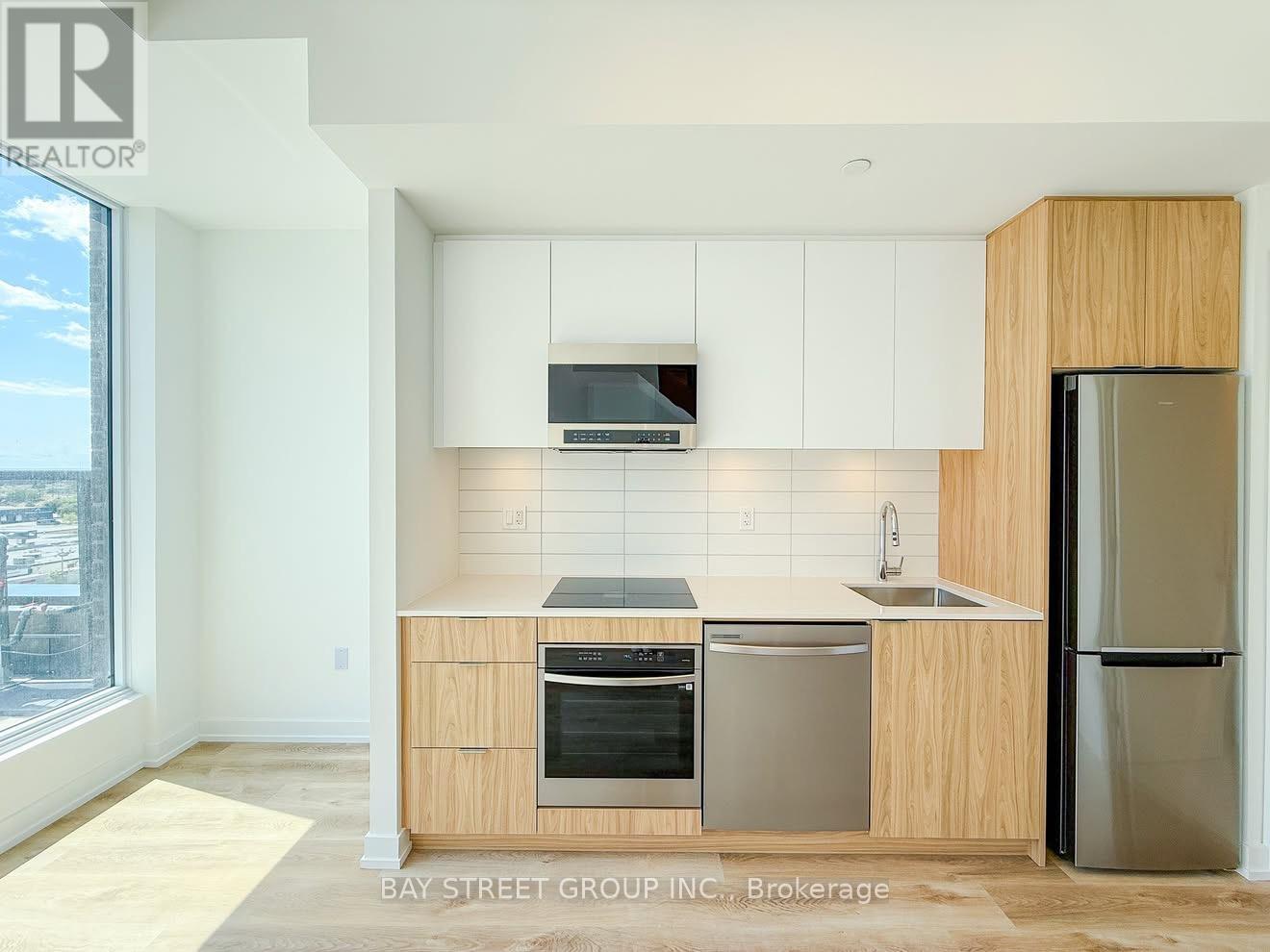 A kitchen with wooden cabinets and stainless steel appliances.