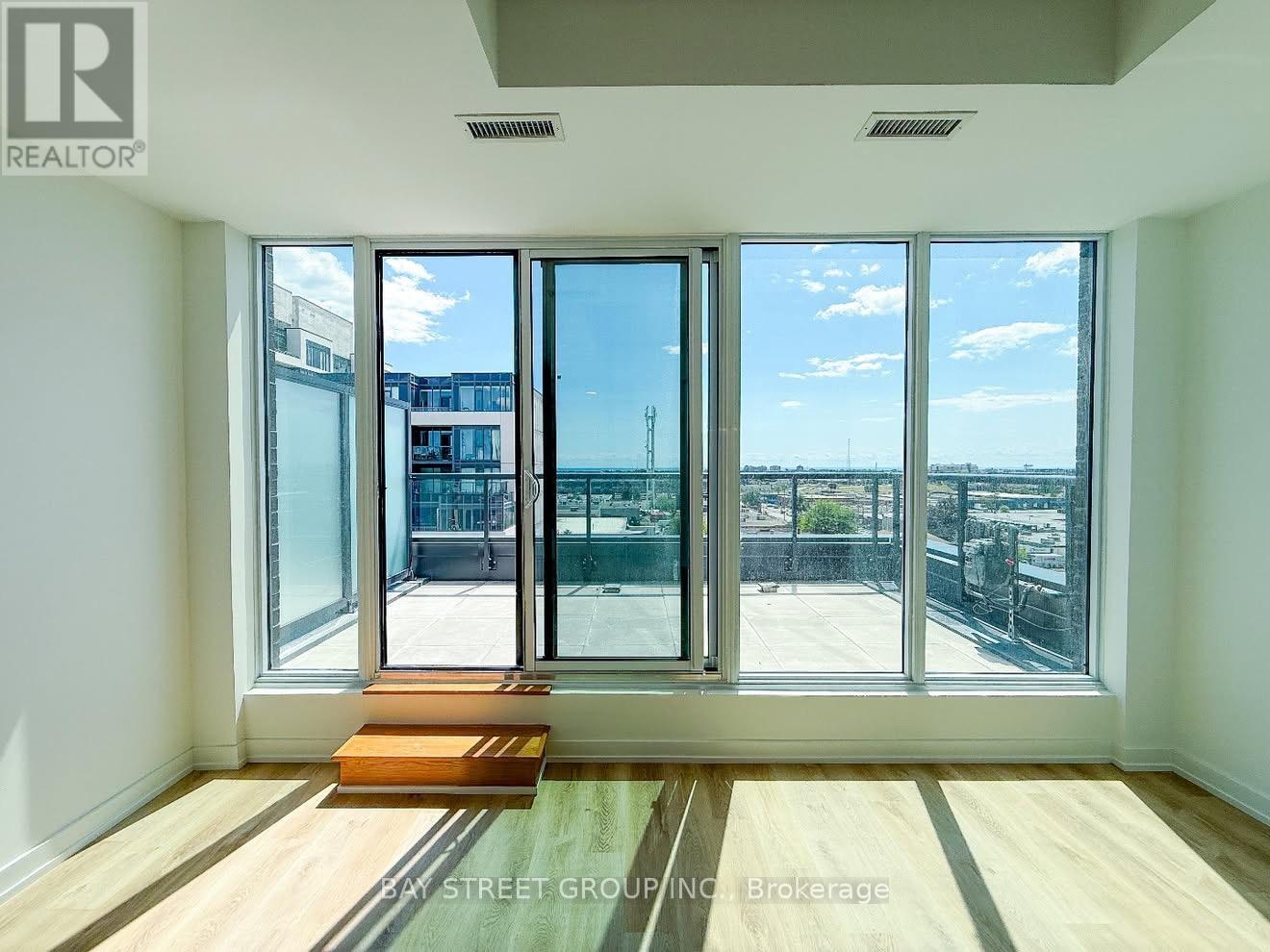 A room with a view of the street and buildings outside.
