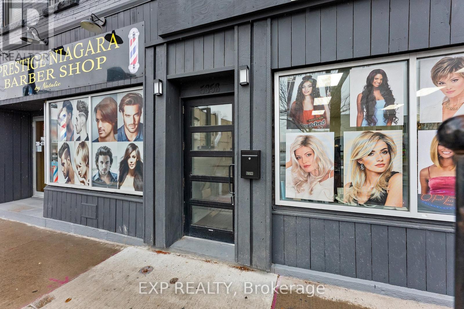 A barber shop named Prestige Nagara is located in a building with a grey exterior.