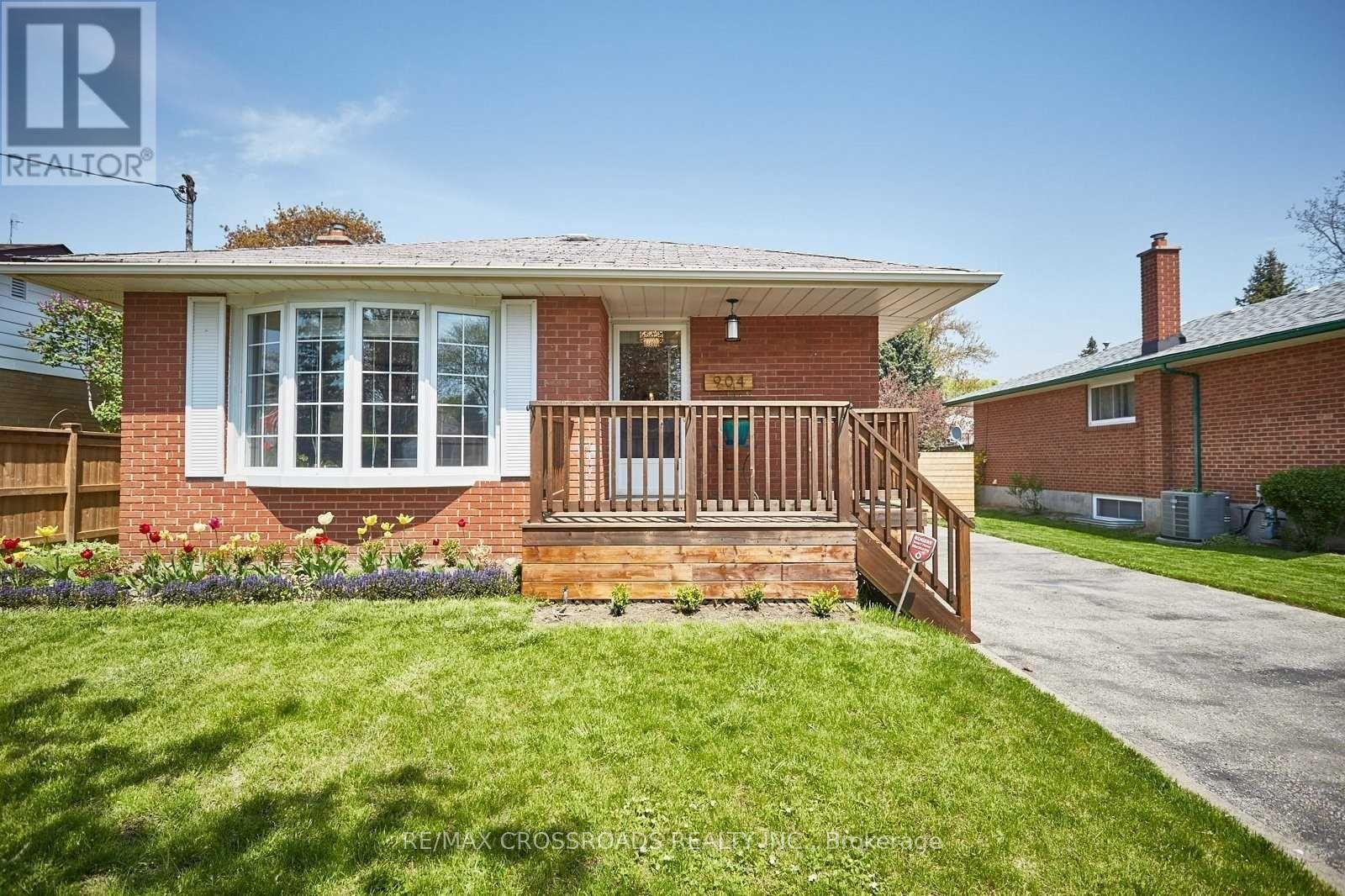 A house with a red brick exterior and a white window.