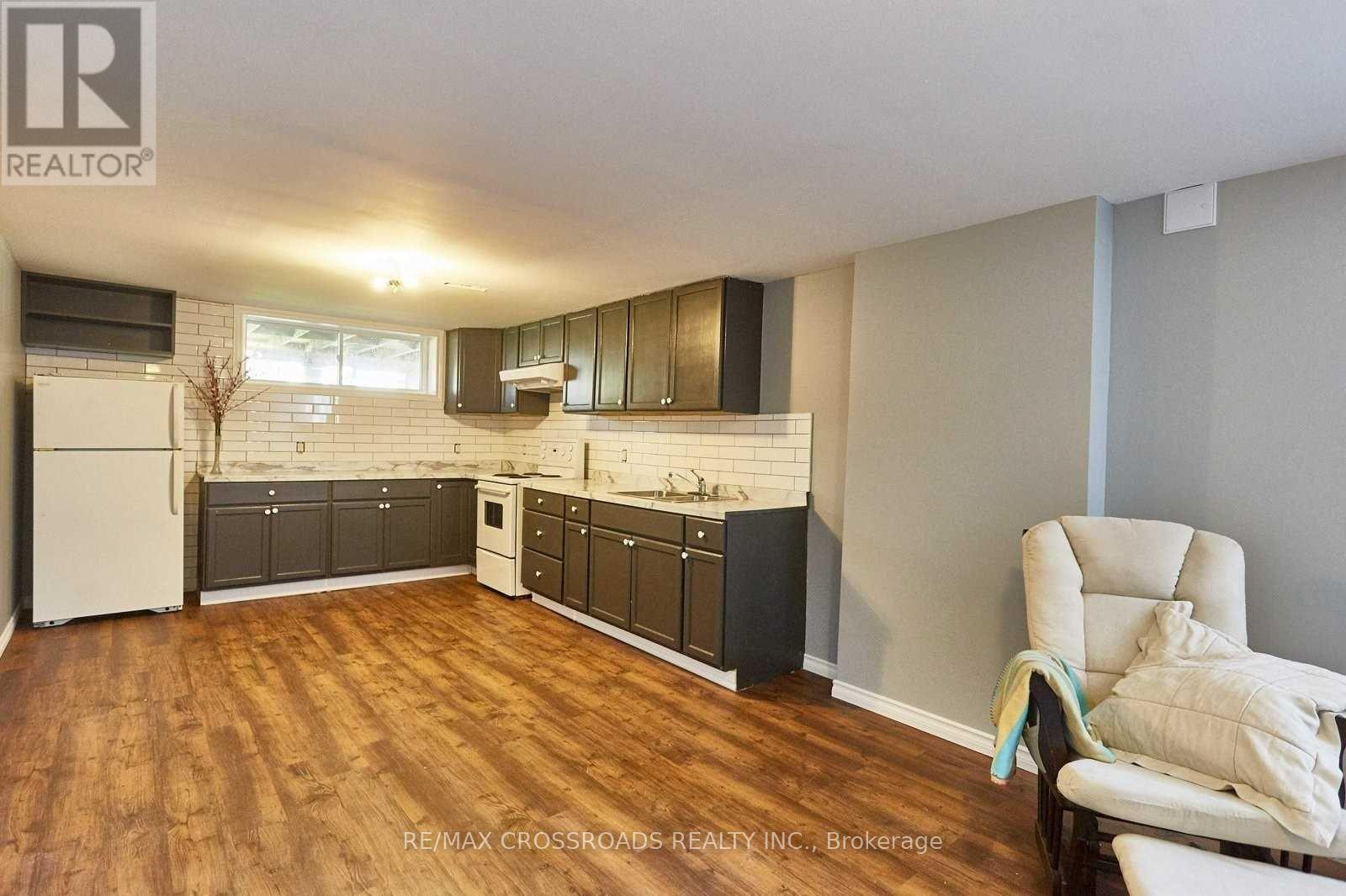 A kitchen with wooden floors and white appliances.