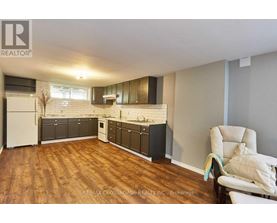 A kitchen with wooden floors and white appliances.