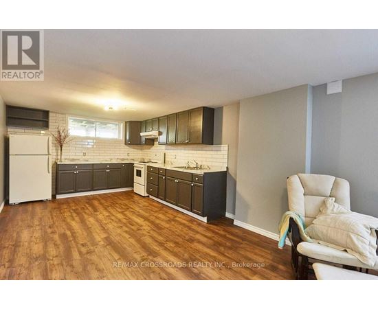 A kitchen with wooden floors and white appliances.