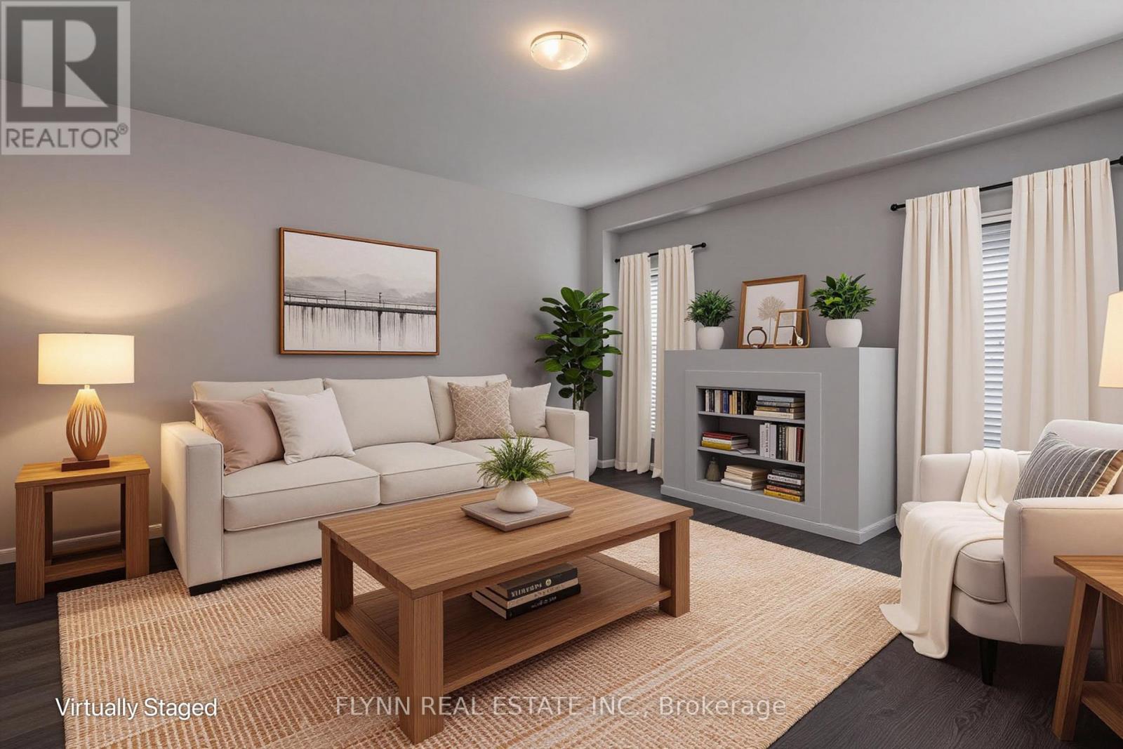 A living room with a white couch, a coffee table, and a bookshelf.
