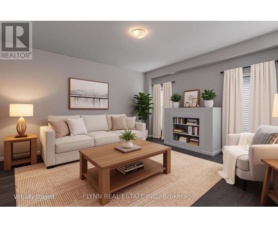 A living room with a white couch, a coffee table, and a bookshelf.