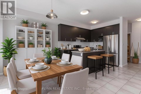 A modern kitchen with a dining table set for two.