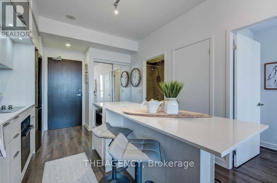 A kitchen with a dining table and chairs in the middle of the room.