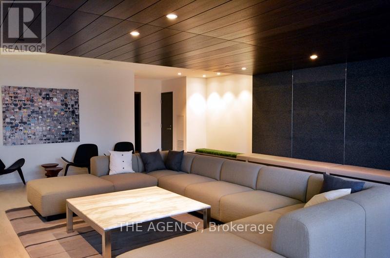 A modern living room with a large sectional sofa and a coffee table.