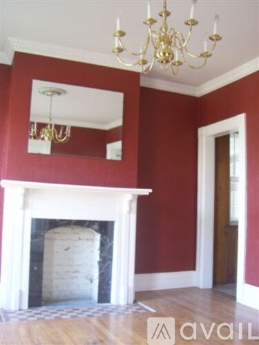 A room with a fireplace and a chandelier.