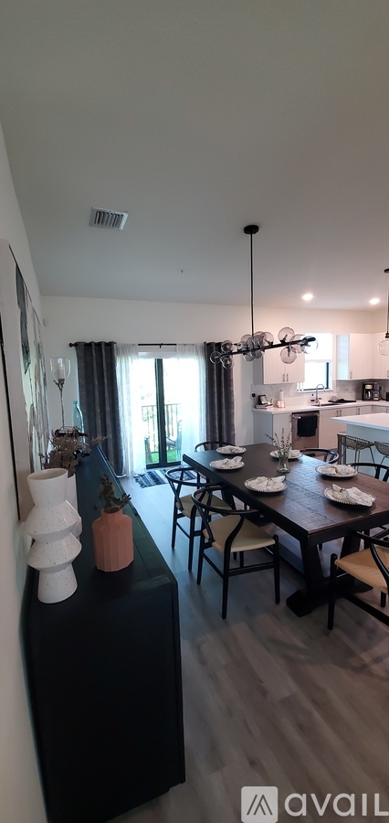 A modern kitchen with a dining table set for four.