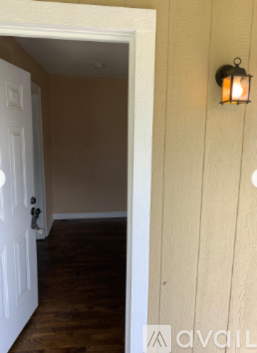 A white door is open to a hallway.
