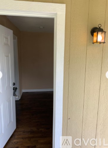A white door is open to a hallway.