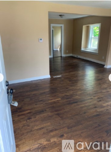 A room with wooden floors and a window.