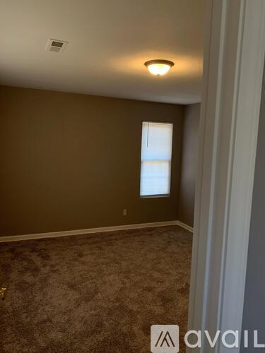 A room with brown walls and a carpeted floor.