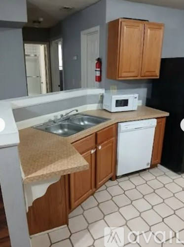 A kitchen with a white dishwasher and a white microwave.