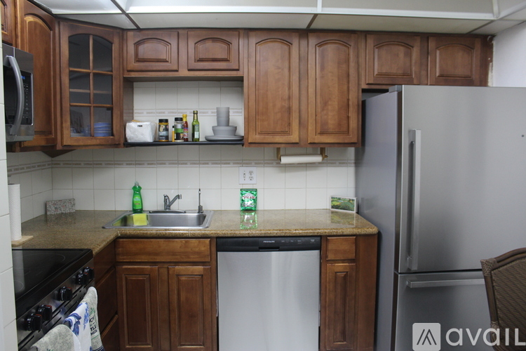 A kitchen with wooden cabinets and a granite countertop.